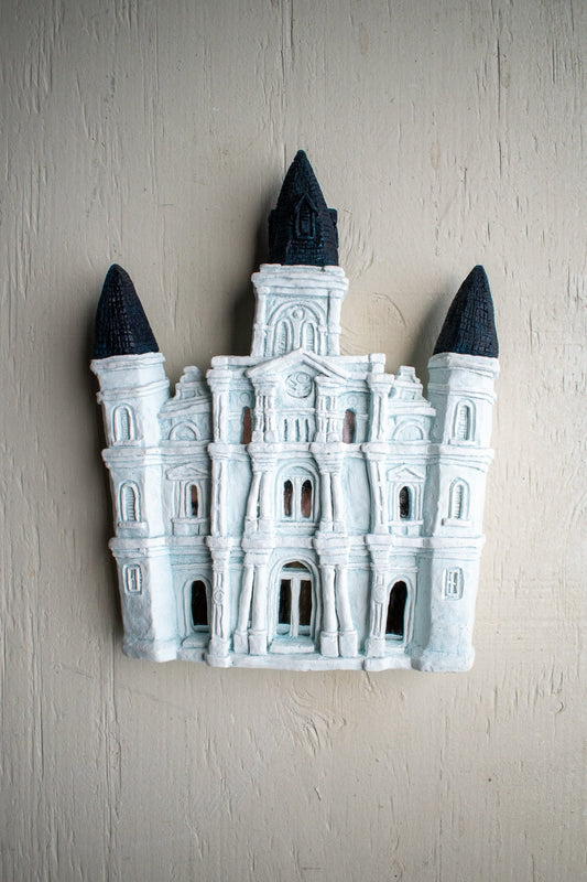 Plaster-molded and hand painted, this artistic rendition of the St. Louis Cathedral has all of the charm of the famous New Orleans church while still being small enough to hang on your wall. Bring a little piece of New Orleans into your home!